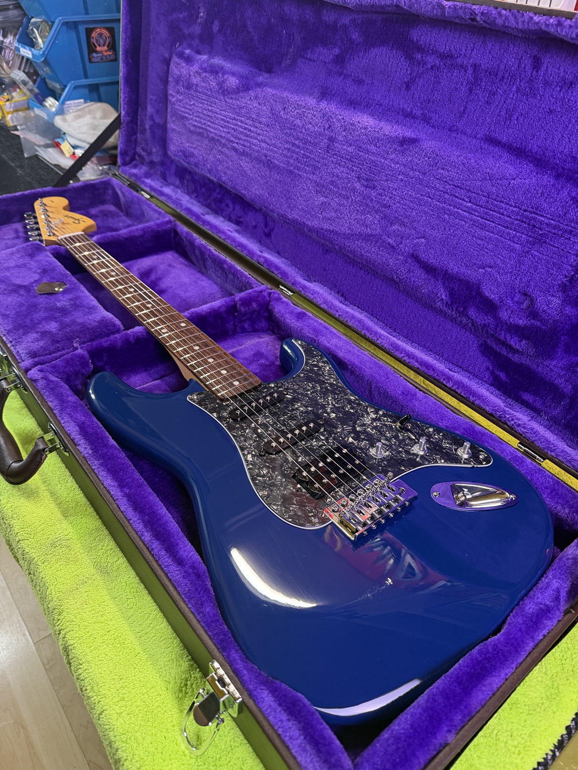 After restoration: full view of blue Squier Stratocaster with black pearloid pickguard and refreshed hardware